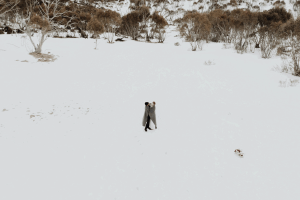 Snowy scene with people standing the middle 